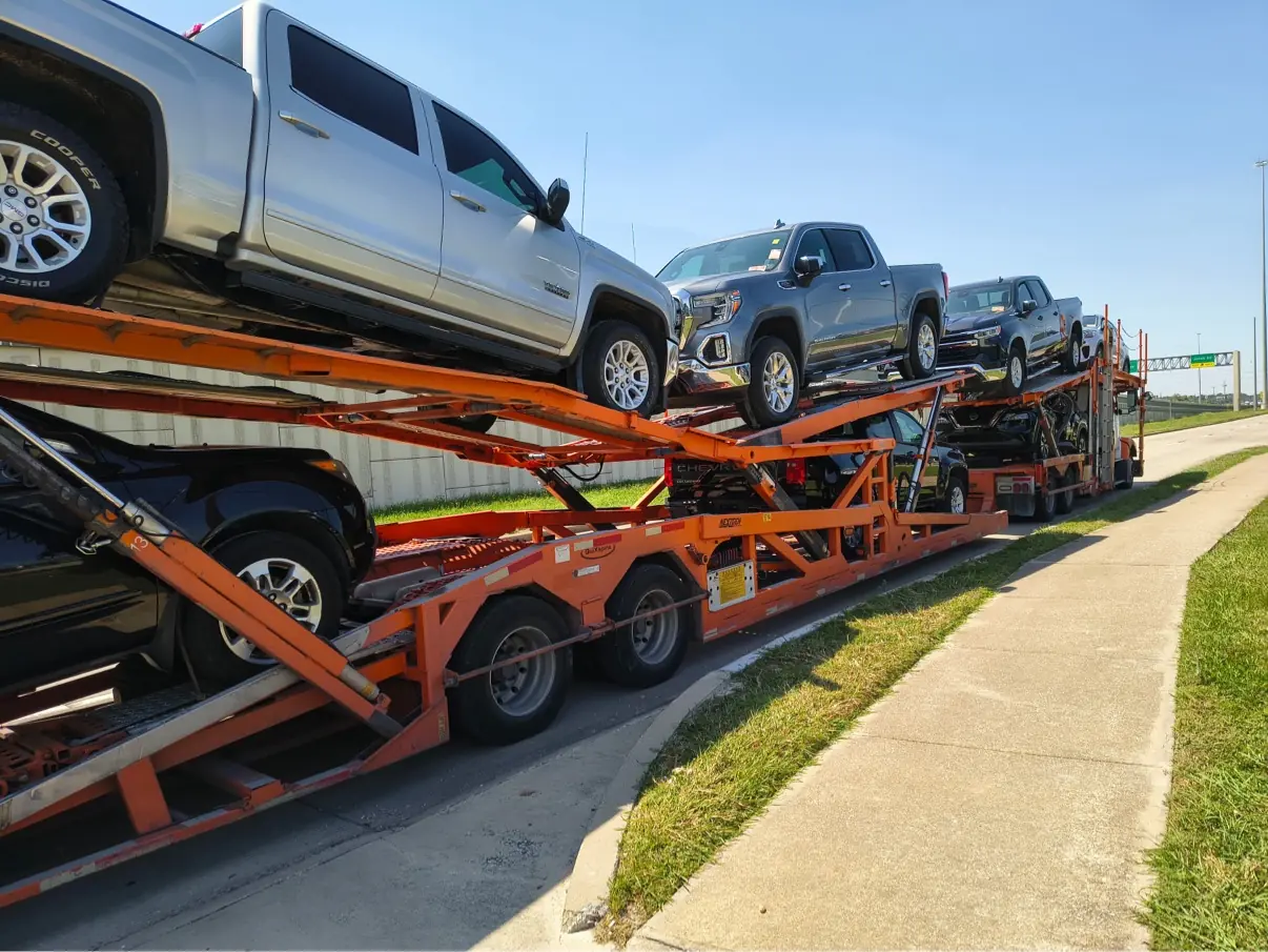 MOV MY CAR trailer carrying pickup trucks bound from Houston to Austin, Texas